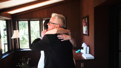 Bride and Dad hug before wedding ceremony