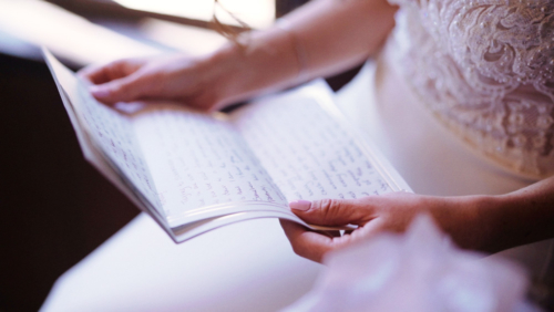 Mt. Woodson Castle Wedding Bride reads groom's letter before ceremony