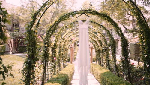 Wedding dress hanging from archway at Westlake Village Inn Westlake Village Inn