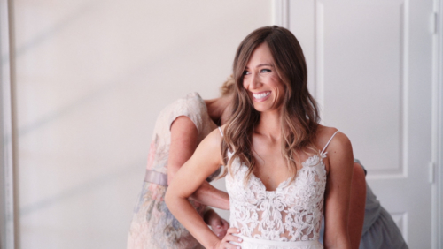 Very happy bride getting dress laced up Westlake Village Inn