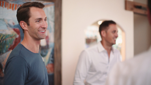 Groom hanging out with groomsmen before wedding