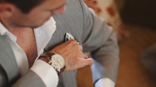 Groomsmen folding suit handkerchief before wedding