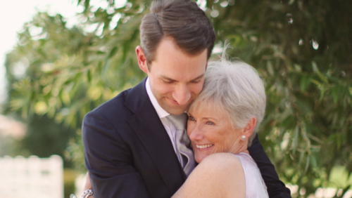 Groom and mother hug before wedding ceremony