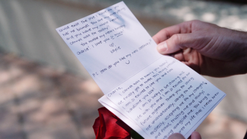 Groom reads card from bride before wedding ceremony at first look Westlake Village Inn