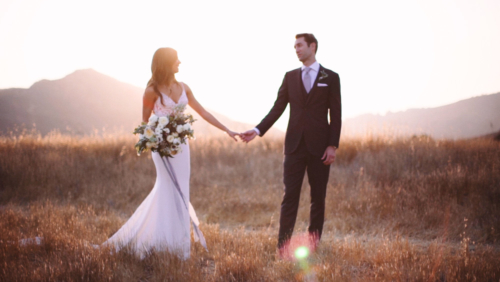 Bride can groom in field with sunlight Malibu