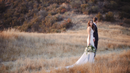 Bride and groom walking in field at Brookview Ranch Malibu