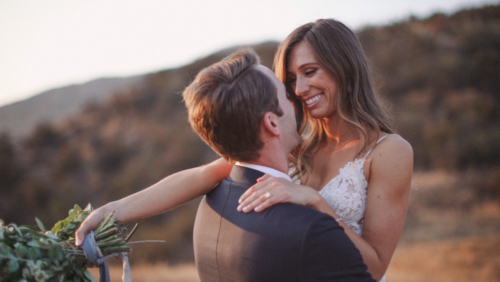 Groom picks up bride at sunset