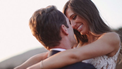 Groom holds bride in field with sunlight at Brookview Ranch Malibu