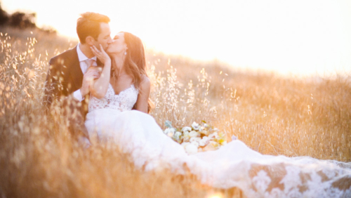 Bride and groom laying in a field at sunset at Brookview Ranch Malibu