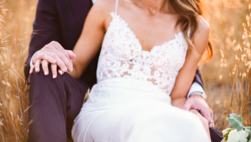 Bride and groom laying in a field at sunset Brookview Ranch Malibu