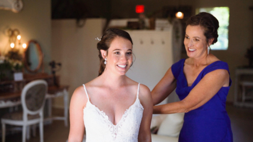 Mom helps bride get ready for wedding