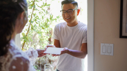 Grooms friend brings card to bride