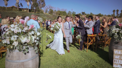 bride and groom walk down the aisle