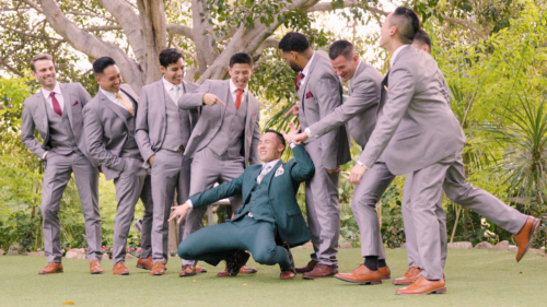 Groom and groomsmen having fun at wedding at Botanica