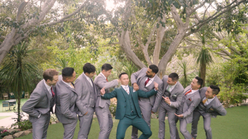 Groom having fun with Groomsmen at wedding at Botanica