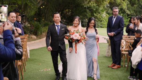 Bride comes down the aisle at Botanica