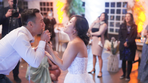 Bride and groom singing to eachother at reception