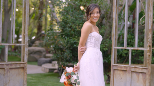 Bride posing in wedding dress at Botanica